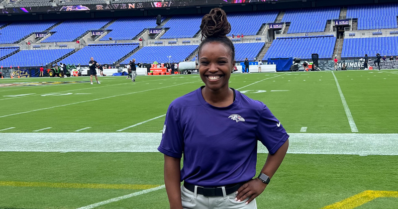Asha Rogers poses in M&T Bank Stadium, home of the Baltimore Ravens. She completed a full-time clinical rotation with the team before graduating from UDPT.