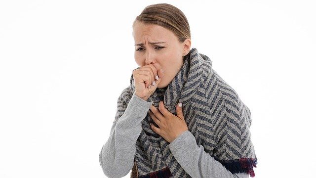 A lady coughing.