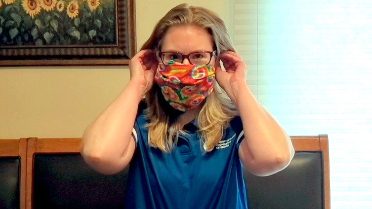 Woman poses wearing a DIY face mask.