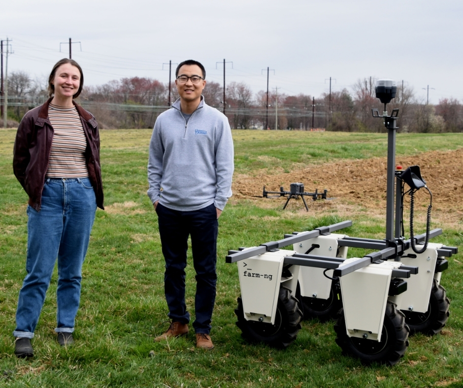 Yin Bao and Erin Magee set up an farm-ng Amiga skid-steering unmanned ground vehicle (UGV).