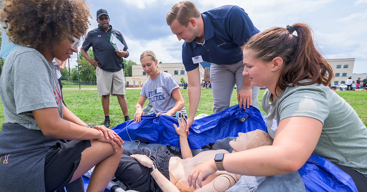 Delaware high school athletic trainers work on a mannequin under the scenario that a cross-country runner suffer exertional heat stroke.