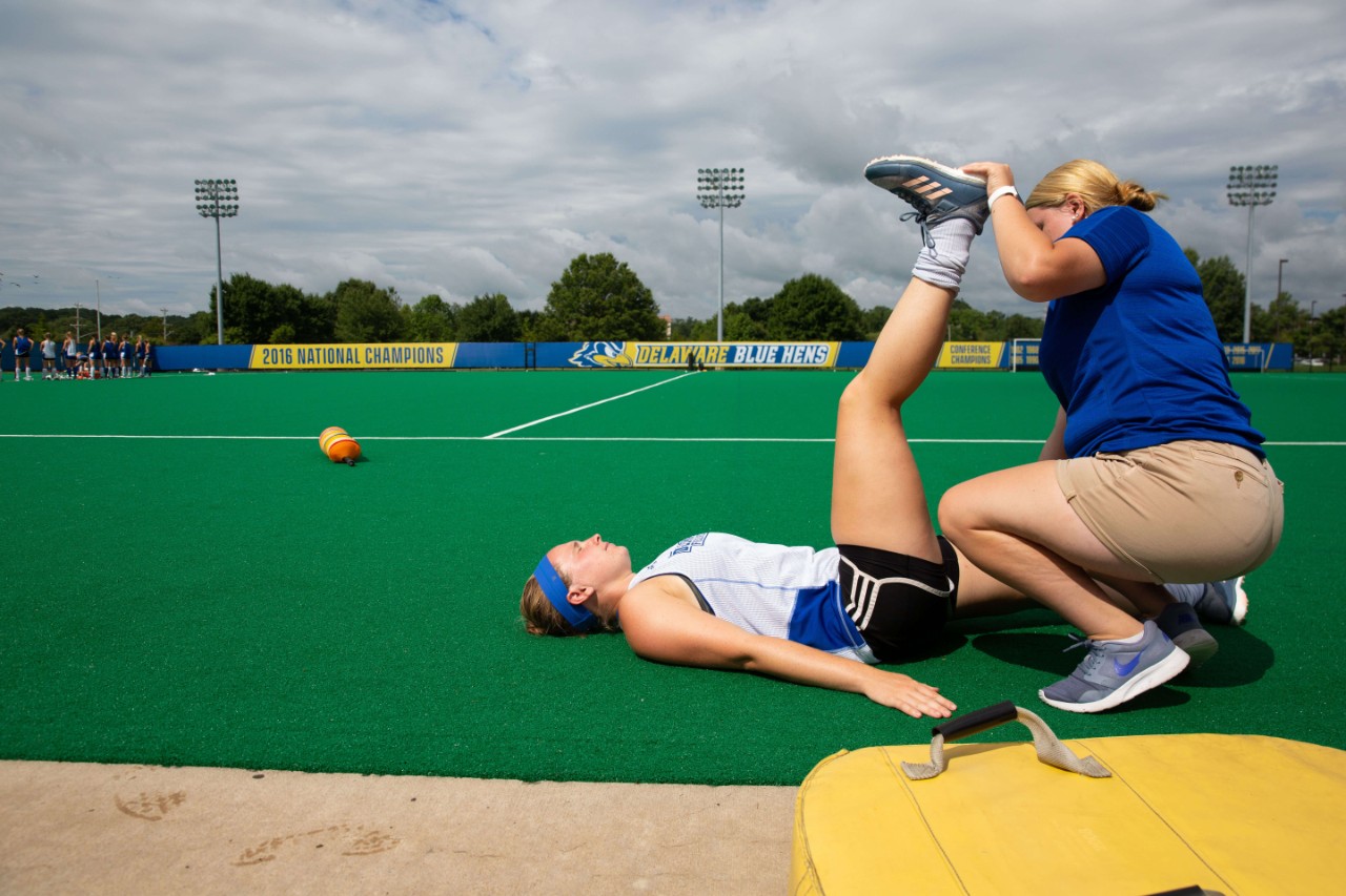Athletic Trainer stretching an athlete's leg
