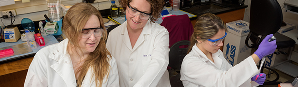 Tania Roth, assistant professor of Psychological and Brain Sciences, along with graduate students Tiffany Doherty and Samantha Keller in their McKinly Laboratory research space. Roth is the recent recipient of a $1.5m grant to support her further research into neuroscience and DNA methylation.