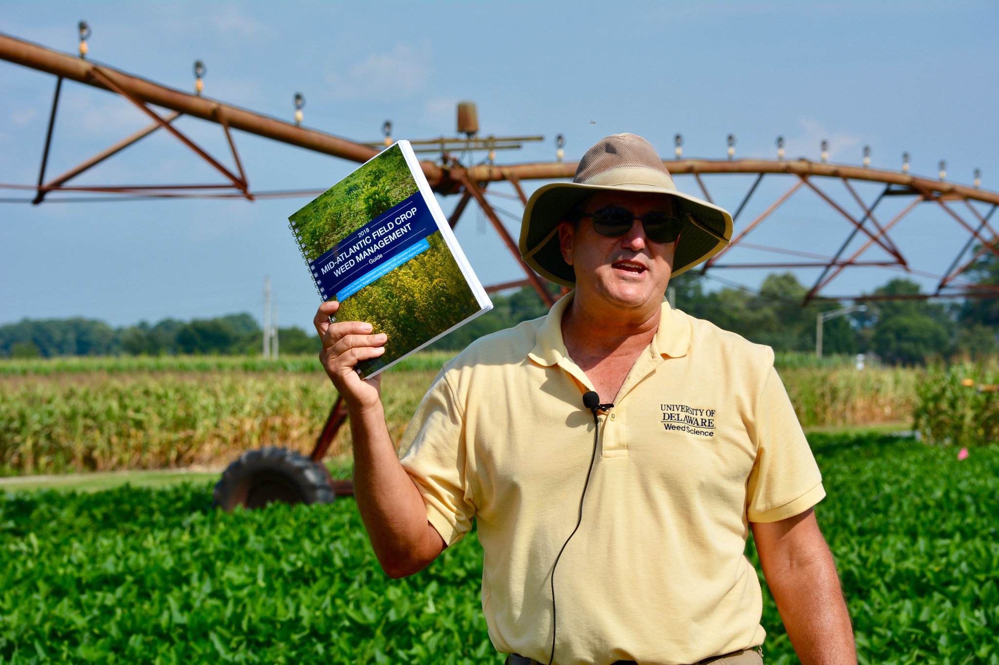 Mark VanGessel holding up weed guide at recent weed day tour