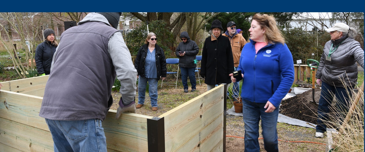 Master Gardener, Tracy Wooten guiding participants in building raised beds