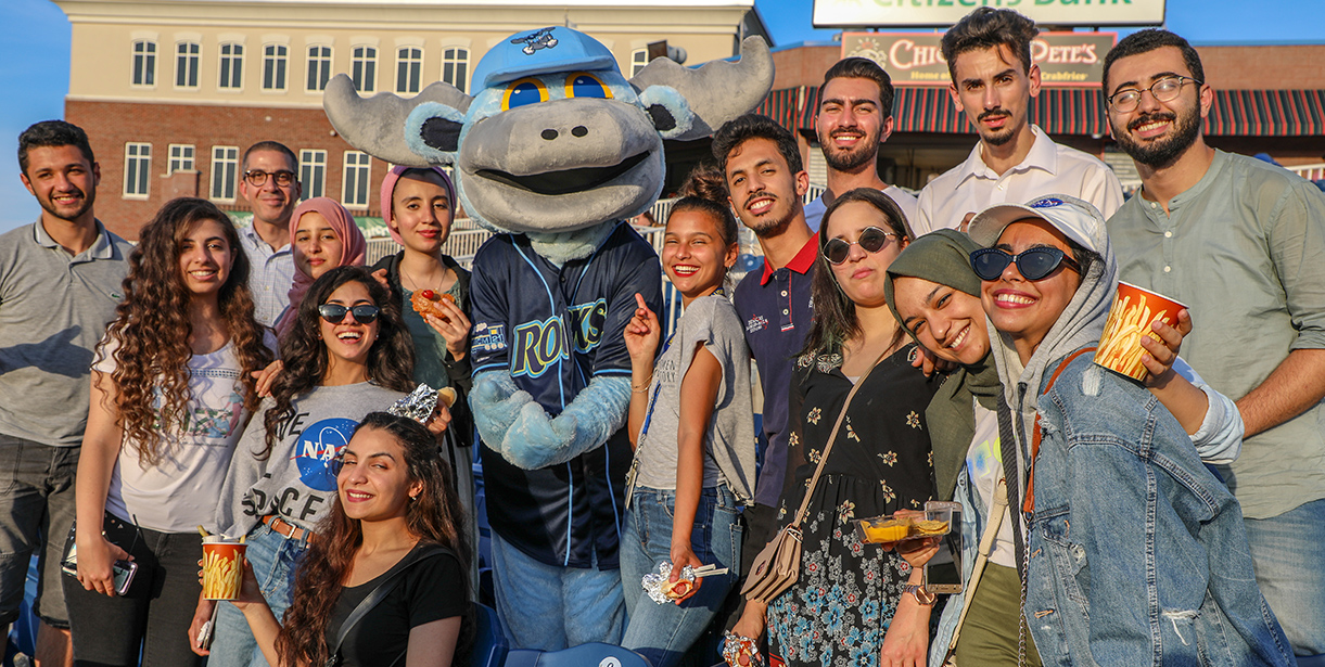 UD MEPI Student Leaders pose for a photo with the Blue Rocks Mascot, Rocky. 