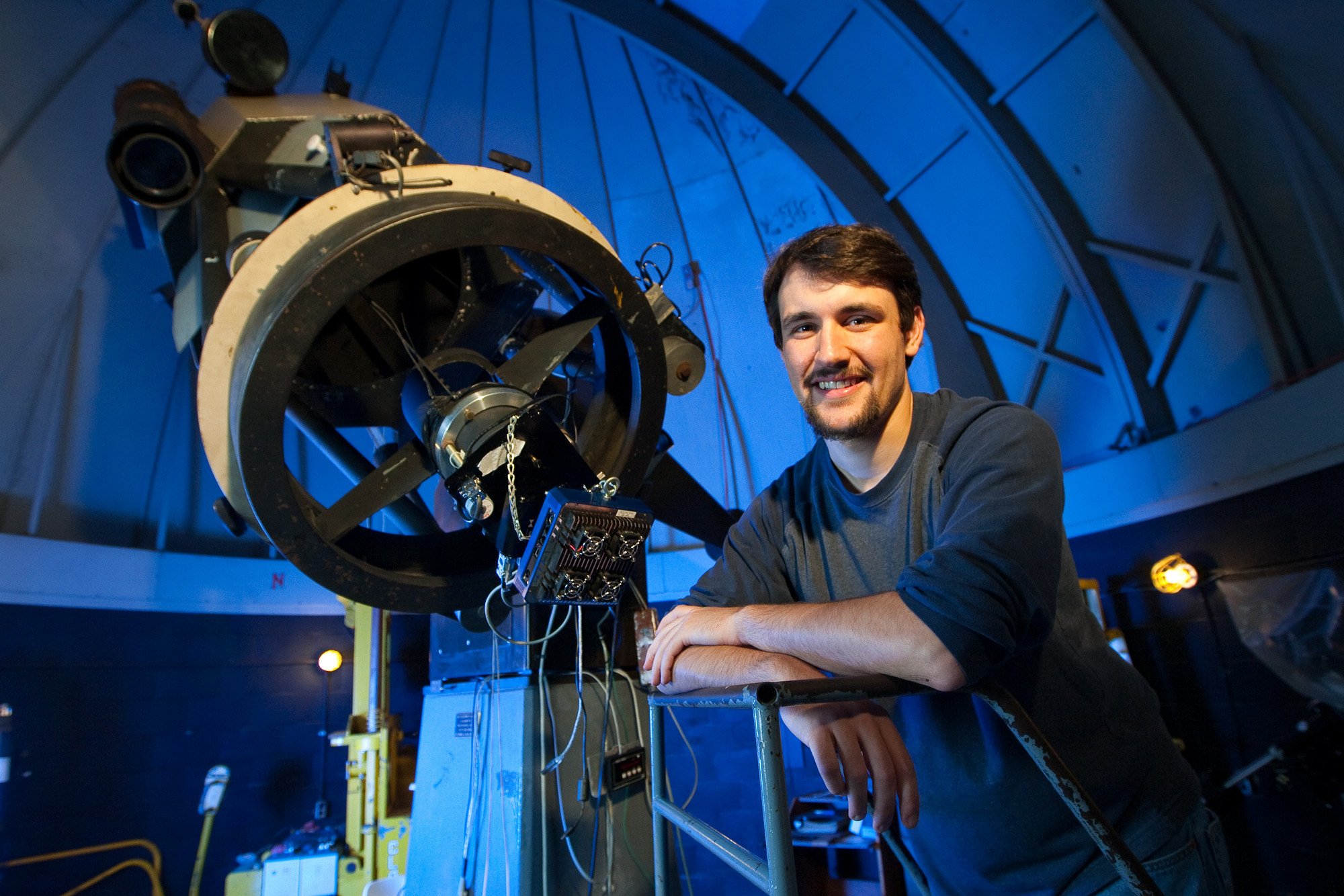 UD Grad student next to the telescope at Mt. Cuba Astronomical Observatory in Greenville, Del. Photo by Kevin Quinlan.