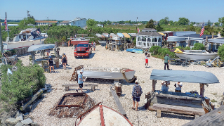 Image of people working on a beach in coastal Delaware.