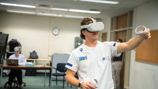 Luke Stuchik checks a patient's vitals via a VR headset.