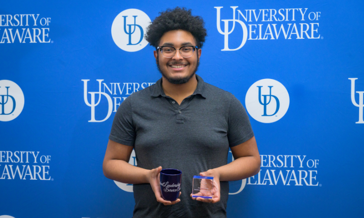 Student holding student leadership and service award