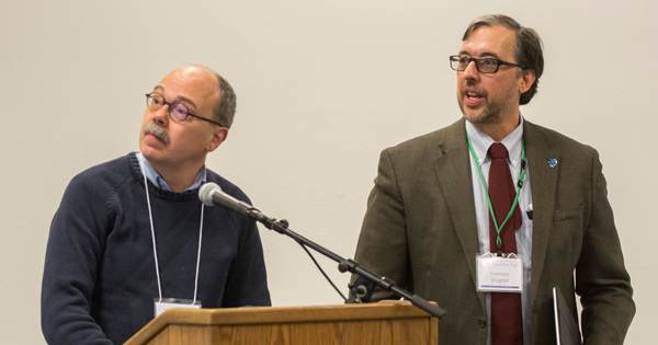 Dan Neumann and Norm Wagner stand at the lectern