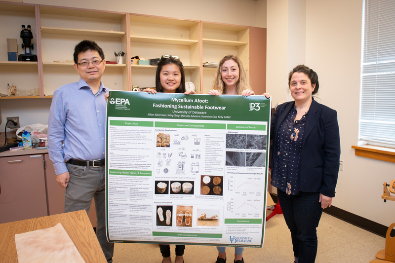Researchers (from left) Huantian Cao, Wing Tang, Jillian Silverman and Kelly Cobb hold the poster they displayed at their booth at the National Sustainable Design Expo in Washington, D.C.