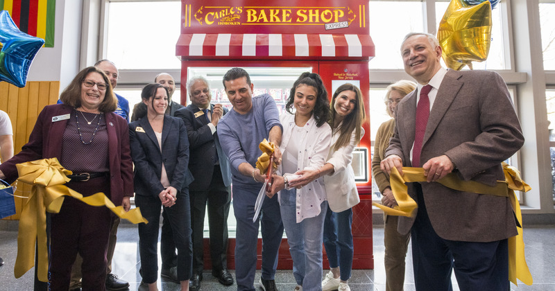 Buddy Valastro, known as the “Cake Boss,” and his daughter, Sofia, cut the ribbon to celebrate the opening of the new cake vending machine in Trabant University Center.