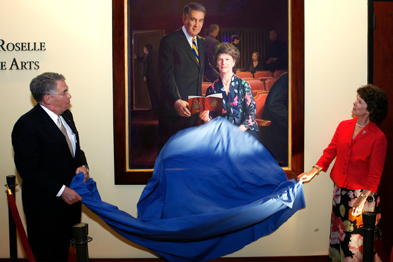 President David Roselle and wife, Louise Roselle, unveil the portrait of themselves that hangs in the Roselle Center for the Arts. 