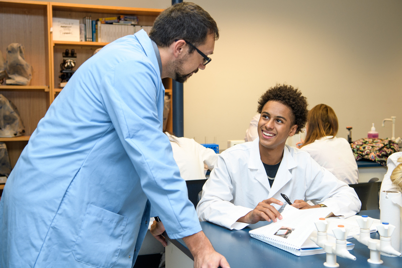 Professor assisting a student in a laboratory setting