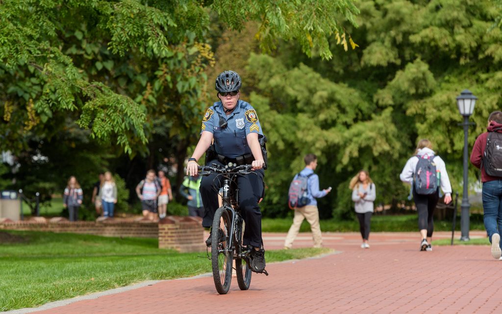 UD Police riding a bike through campus