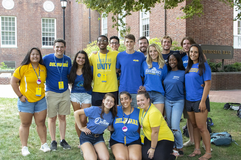 A group of young students wearing blue & gold UD shirts