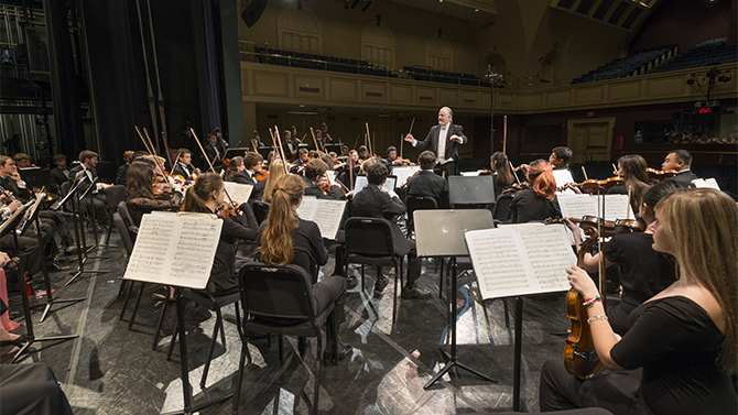 The University of Delaware Symphony Orchestra warms up prior to a performance in Mitchell Hall.