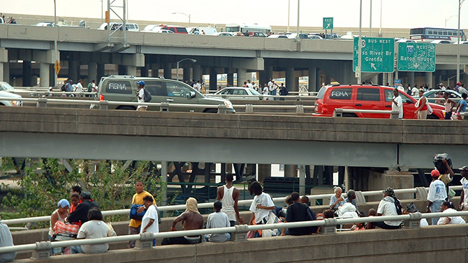 New Orleans, LA, Wednesday, August 31, 2005 -- People standing on the overpasses and bridges to get out of the New Orleans flood waters. New Orleans was under a mandatory evacuation order as a result of flooding caused by hurricane Katrina. Marty Bahamonde/FEMA