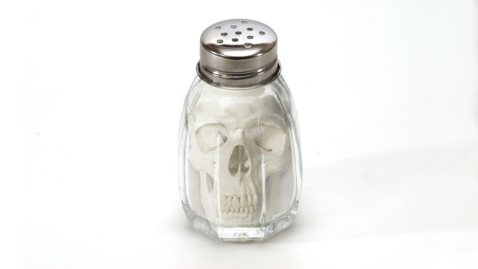 Salt tumbler with skull inside indicating the danger of overconsumption