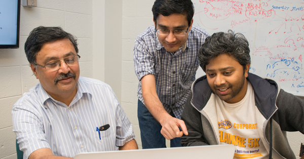 Left to right, pProfessor Vijay Shanker reviews data with graduate students Samir Gupta and Ashique Mahmood. 
