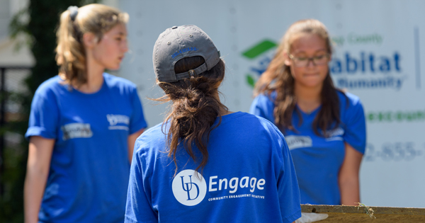 091117 Comm Engage Initiative three first-year Habitat Humanity 600x315 on 082517 Students carry materials out of the backyard of house in Laurel, Del., making room to build a small shed for storage. Every house built or restored by Habitat for Humanity receives a small shed. 