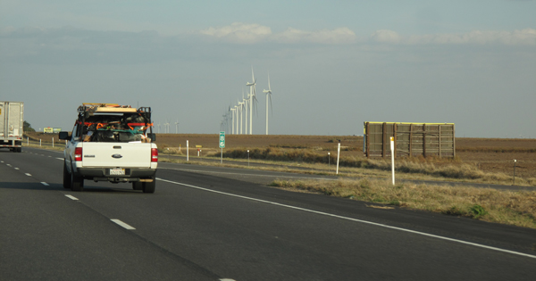 A row of wind turbines generate energy in the Midwest.