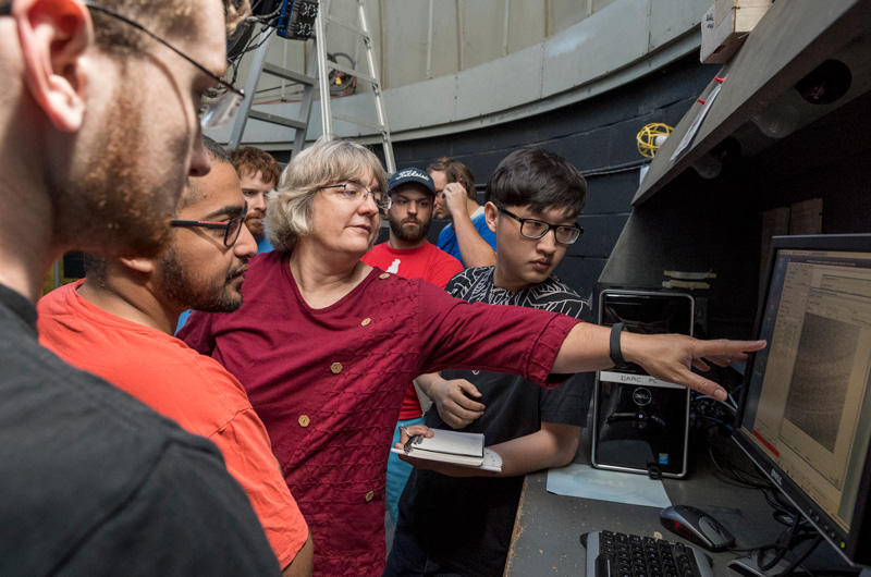 Dr. Judith (Judy) Provencal holds her Astronomy class at the Mount Cuba observatory in Wilmington where she explains the telescopes, uses and applications and shows students how to identify objects in the sky. The oldest telescope will be used for the upcoming solar eclipse in August 2017. 

Students Pictured: Alex Wise (beard, royal blue T-shirt), doctoral student, astrophysics
Rebecca MacInnis, doctoral student, astrophysics
Taylor Strein (cap, red T-shirt), senior, astrophysics
Mohammed Aldawsari, sophomore, mechanical engineering
Tyler Hobbs (tall guy), senior, mechanical engineering (and his full name is George Tyler Weymouth Hobbs … so he is no doubt related to some of Delaware’s most illustrious families…)
Yue Feng, senior, mechanical engineering
Sean Kenny, black T-shirt, senior, physics