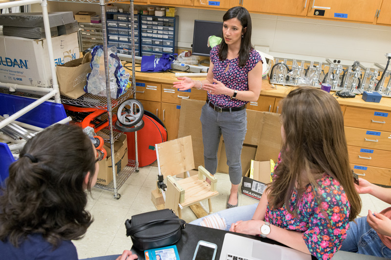 Sarah Rooney, an assistant professor of biomedical engineering at the University of Delaware, advises students as they design a device for children with brittle bone disease.