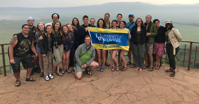 Jake Bowman (center, kneeling), professor and chair of wildlife ecology, has led nine programs to Tanzania, partnering with fellow UD faculty, local residents and conservation groups. 