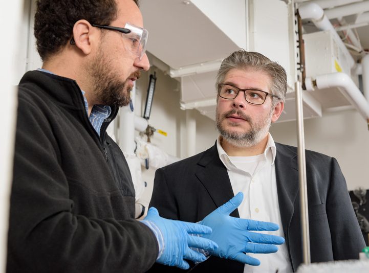 Joel Rosenthal, associate professor of Chemistry and Biochemistry, with post doctoral fellow Abderrahman Atifi in their Brown Hall lab. The pair recently published a paper in the American Chemical Society Catalysis journal titled 