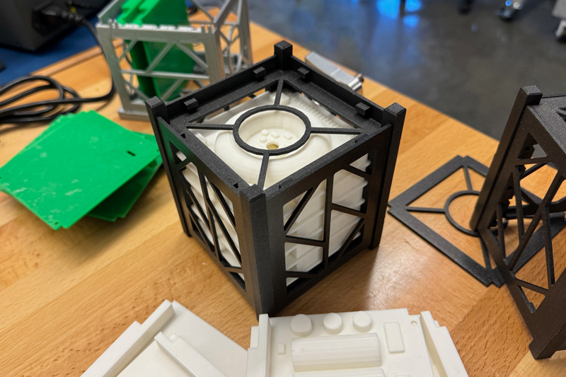 A CubeSat is a small, modular satellite that can fit in your hand. The CubeSat that will be Delaware’s first orbital spacecraft is about three times bigger than this model.