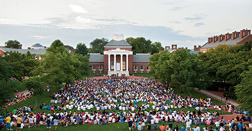 Students on the green during twilight induction ceremony