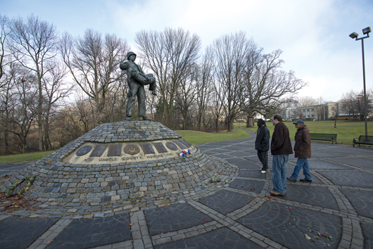 Ben Fleury-Steiner (center) with fellow veterans at the Vietnam memorial in Wilmington, Del.
