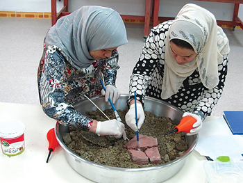 Iraqi women working on pottery pieces