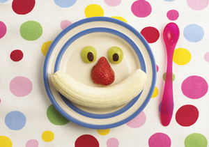 Plate with smiling face made of fruit