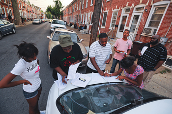 Yasser Payne and his research team help Wilmington residents complete surveys in 2010 for their People’s Report study.