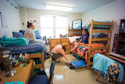 three girls in a dorm room