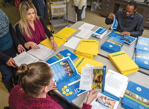 Students and employees preparing admissions packages