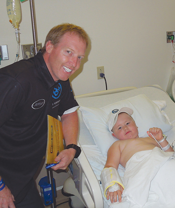 Al Carter visits a young patient battling blood disease at the Peyton Manning Children’s Hospital, Indianapolis, in 2012. The visits are part of Carter’s efforts to support the Wilmington-based B+ Foundation, which assists families of children who have cancer.