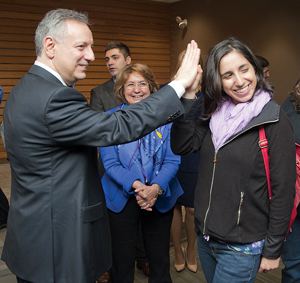 President Dennis Assanis gives a UD student a high-five