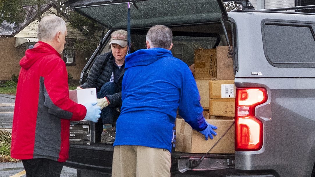 Michael (Mike) Gladle, Director of Environmental Health & Safety and Mark Seifert, Director, Emergency Management at UD’s Public Safety, gather PPE donations from around the campus to donate to Nikki Testa, from the Delaware Emergency Management Agency. 