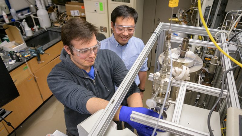 COE-Brady-Xu-Thermochemical_H2O_Splitting-112019 Casper Brady (gray sweatshirt) is a doctoral student in Engineering who's the first listed author of a new paper (titled "Integration of thermochemical water splitting with CO2 direct air capture") explaining an integrated process using only thermal solar energy as the input for a thermochemical method of splitting water to produce Carbon Dioxide, H2, O2, and electricity. The paper was co-authored with Mark E. Davis of Caltech and Bingjun Xu (blue shirt) of the University of Delaware and appeared in the Proceedings of the National Academy of Sciences on November 21, 2019.