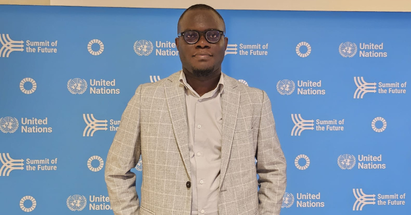 John Oluwadero standing in professional attire while attending the 2024 United Nations Summit of the Future