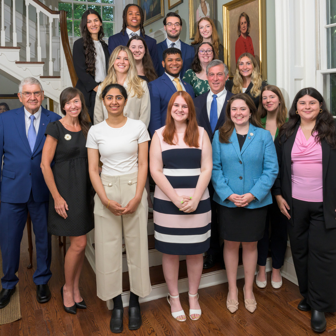 Group photo of students and leadership in professional dress gathered on the steps of the Governor's Mansion in Dover, Delaware 