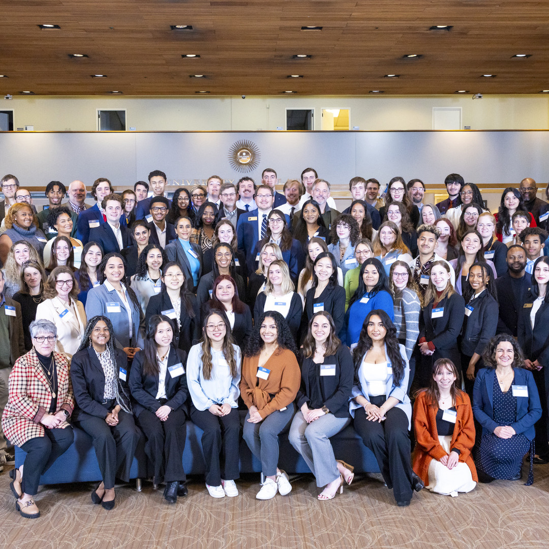 Large group photo of students, faculty and staff in professional dress at the SNF Ithaca National Student Dialogue event in 2024