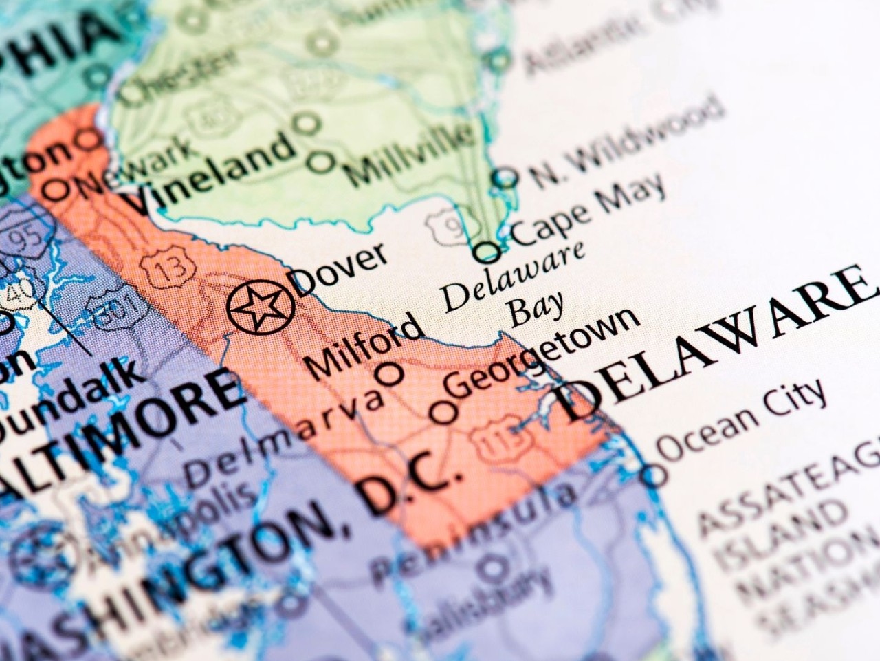 Photo of a multicolored map of the United States with a close up focus on the state of Delaware