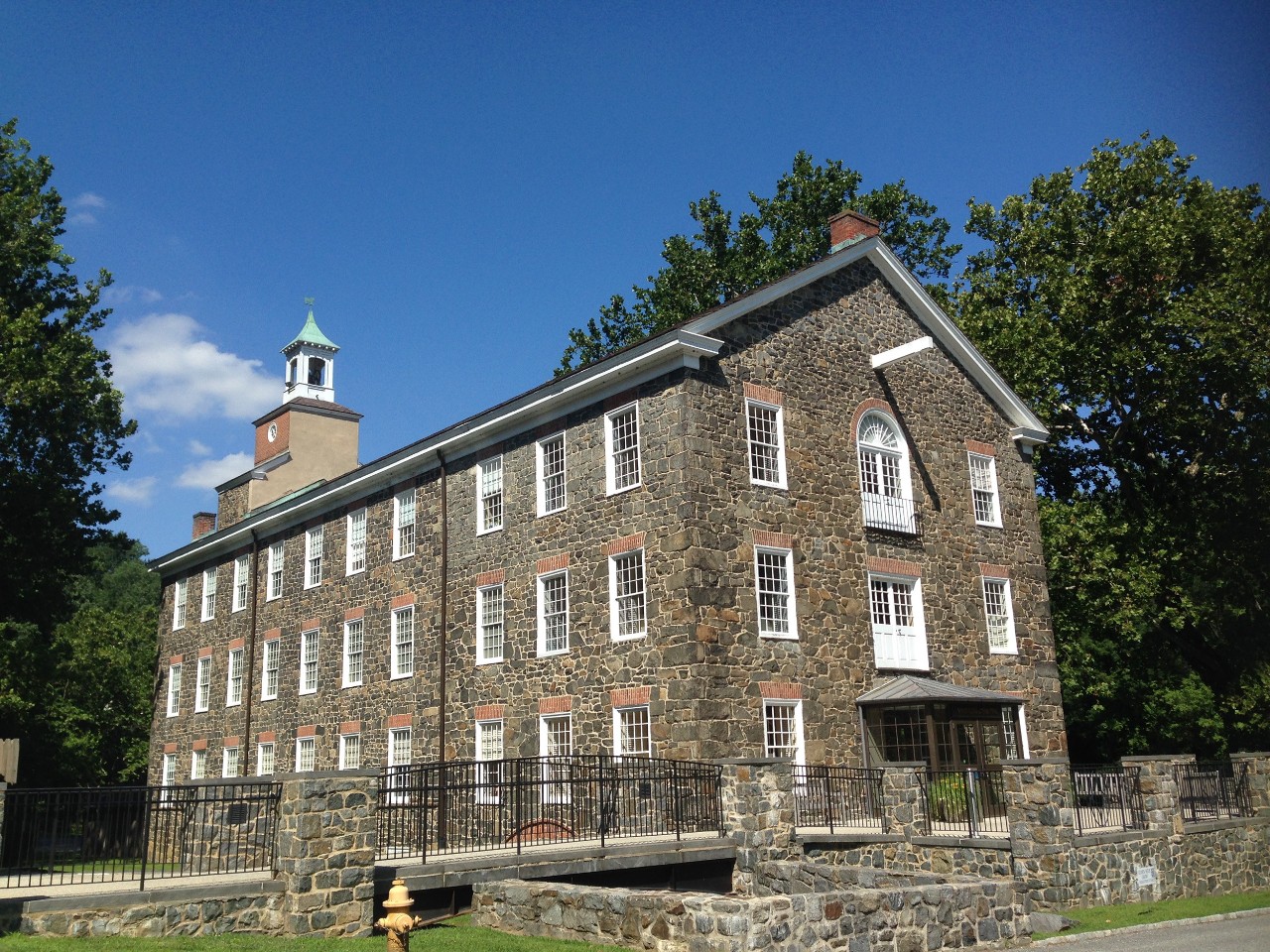 Photo of the original "Henry Clay" stone mill building on the Brandywine River on the grounds of Hagley Museum and Library in Wilmington, Delaware