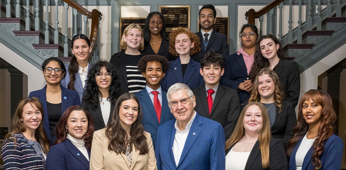 Graduate and undergraduate students stand in professional business attire with founder of the Legislative Fellows Program, Jerome R. Lewis and Program Manager, Lisa Moreland Allred