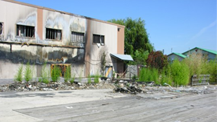Image of an abandoned industrial lot and an example of a brownfield